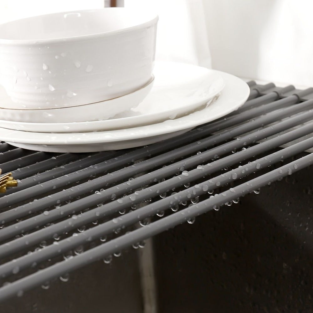 Gray roll-up rack spanning the sink