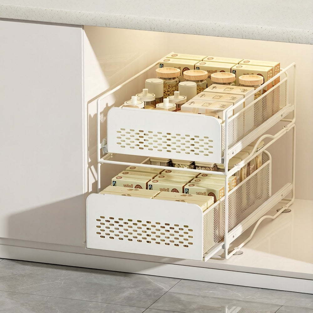 Cream sliding drawer baskets stacked under a kitchen sink