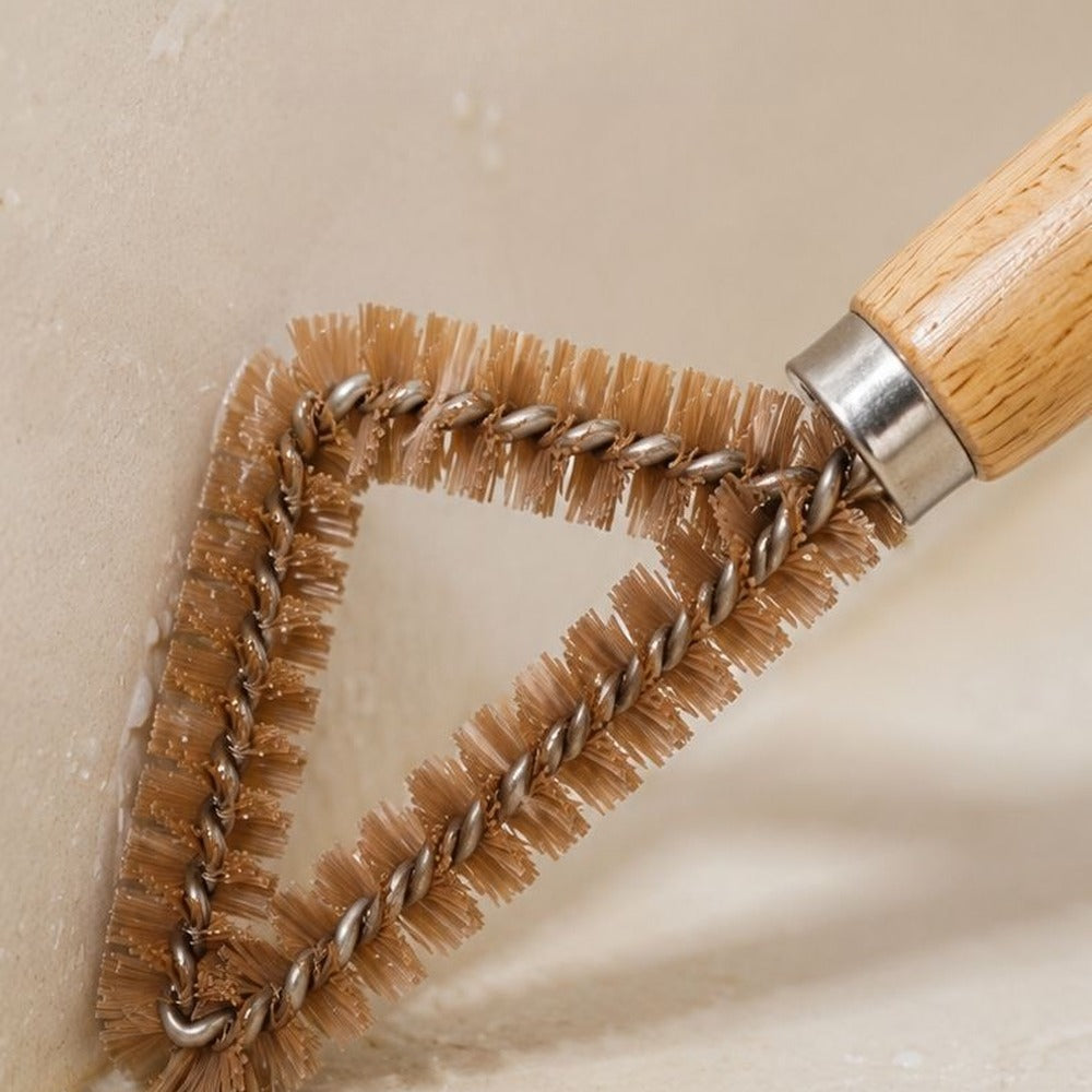 Short stiff bristles scrubbing grime